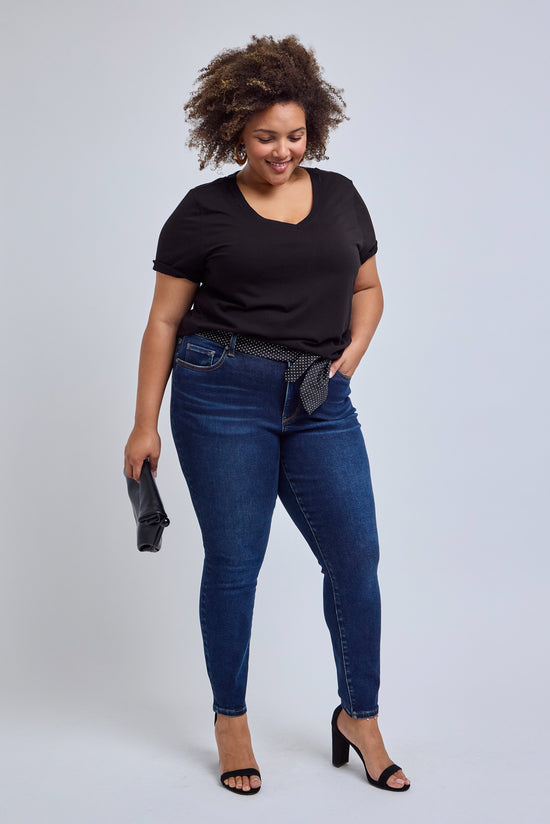 Woman wearing a black v-neck tee and dark skinny jeans