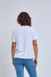 Person wearing a plain white t-shirt and blue jeans on a light gray background