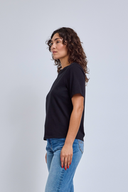 Model wearing a black crew neck t-shirt and jeans