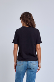 Back side of woman wearing a black t-shirt and jeans