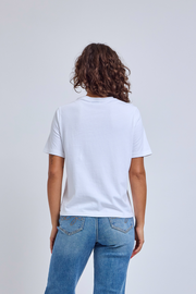 Person wearing a white t-shirt and blue jeans on a plain background