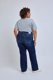 Person wearing blue jeans and a gray t-shirt on a white background