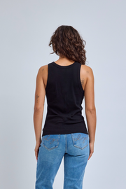 Person wearing a black tank top and blue jeans on a light gray background