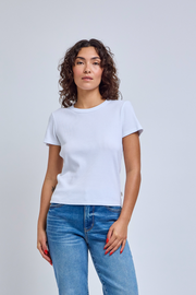 Woman wearing a plain white t-shirt and blue jeans against a light gray background | model-size: 4