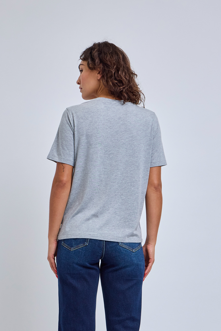 Person wearing a gray t-shirt and blue jeans on a plain background
