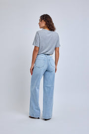 Person wearing light blue jeans and a gray t-shirt on a white background