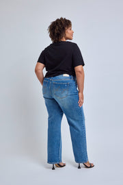 Person wearing blue jeans and a black shirt on a white background