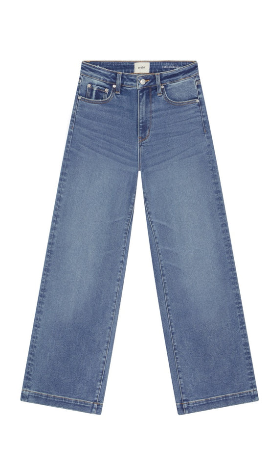 Wide leg blue jeans on a white background