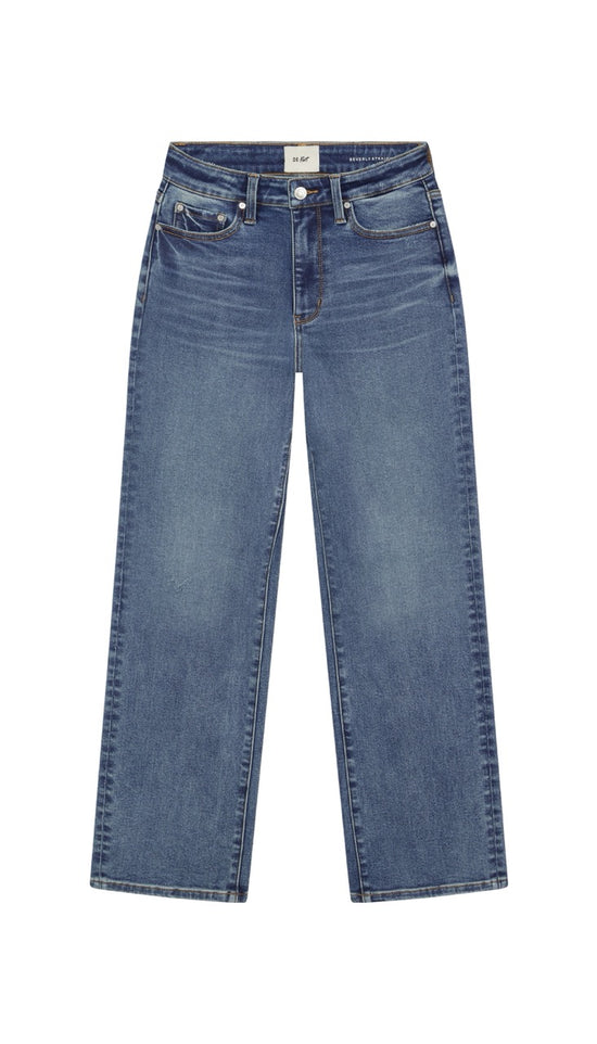 Straight leg blue jeans on a white background