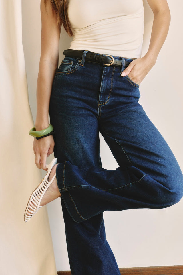 Image of a woman wearing dark denim and a white top