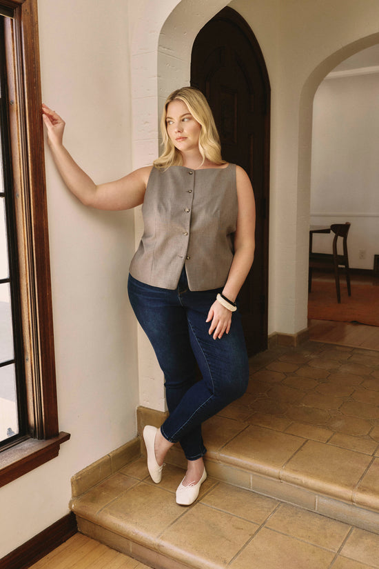 Woman standing on a staircase in a home interior | model-size: 16