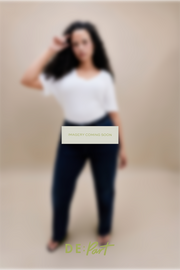 A model wearing a white t-shirt and dark blue jeans is shown in a blurred studio setting with a central 'IMAGERY COMING SOON' overlay and 'DE:Part' branding at the bottom.