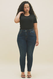 Video of a woman wearing a black crew t-shirt and dark skinny jeans.