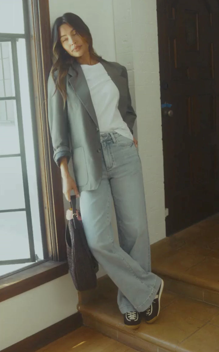 Inclusive women’s wide leg denim shown in motion inside a beautiful home